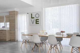 Vertical sheers offer privacy and tons of light in a modern kitchen