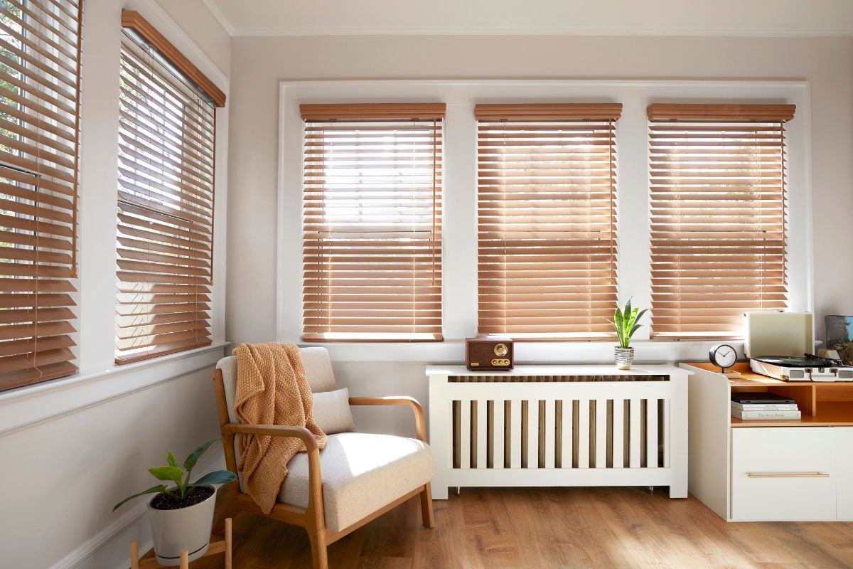 Real wood blinds in a natural brown tone in a modern sitting room.