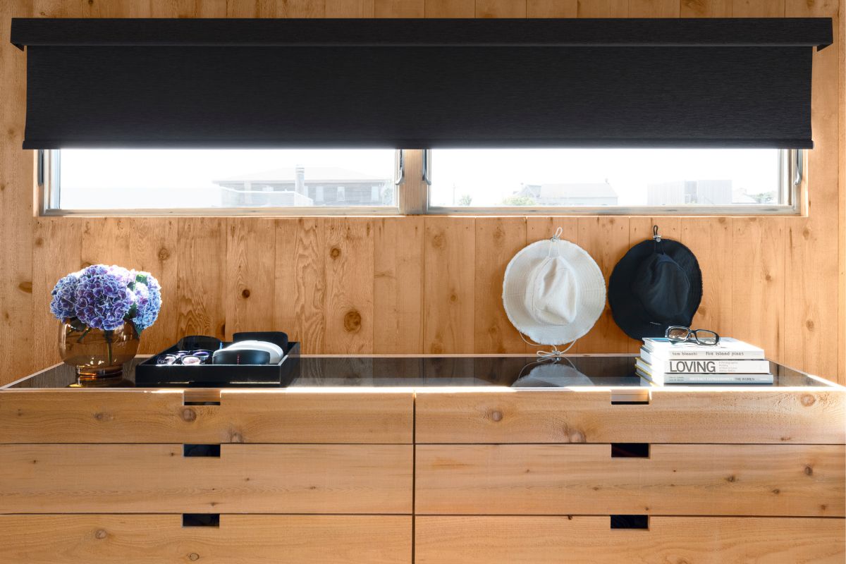 Black roller shades on a short and wide window.