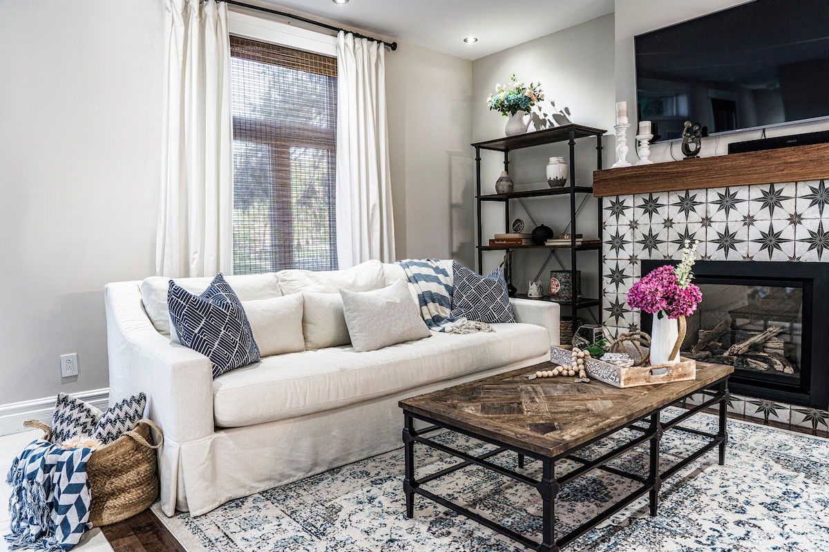 Drapery layered with sheer bamboo shades in a modern eclectic living room.